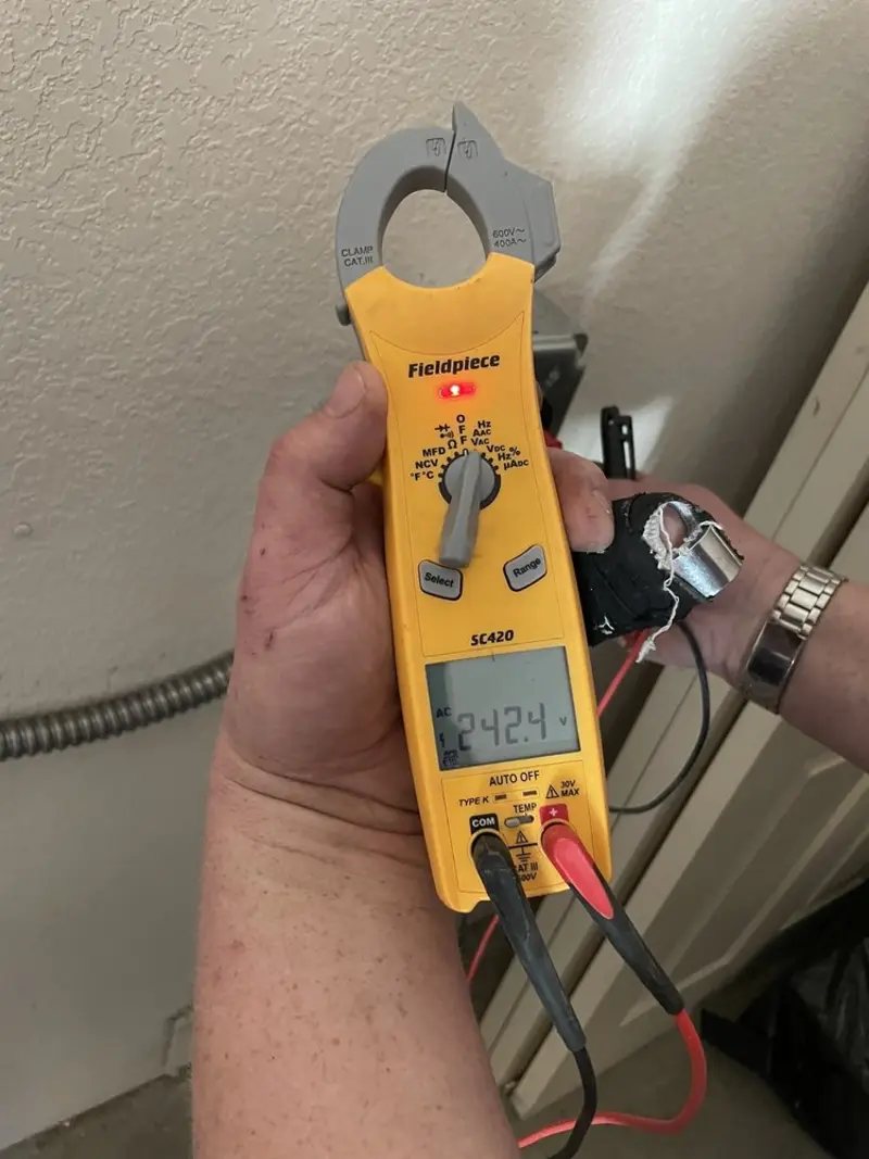 Voltage testing with clamp meter during Outlet Installation in Ellington